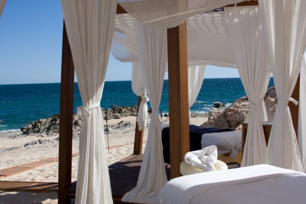 Massage tables await on a tranquil beach in Mexico.