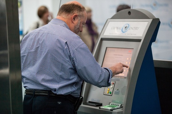 Man using a new Global Entry kiosk at Newark Liberty International Airport.