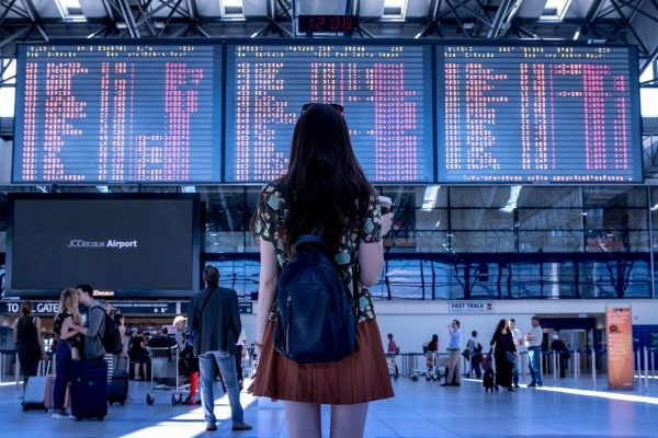 woman standing in an airport looking at the schedule