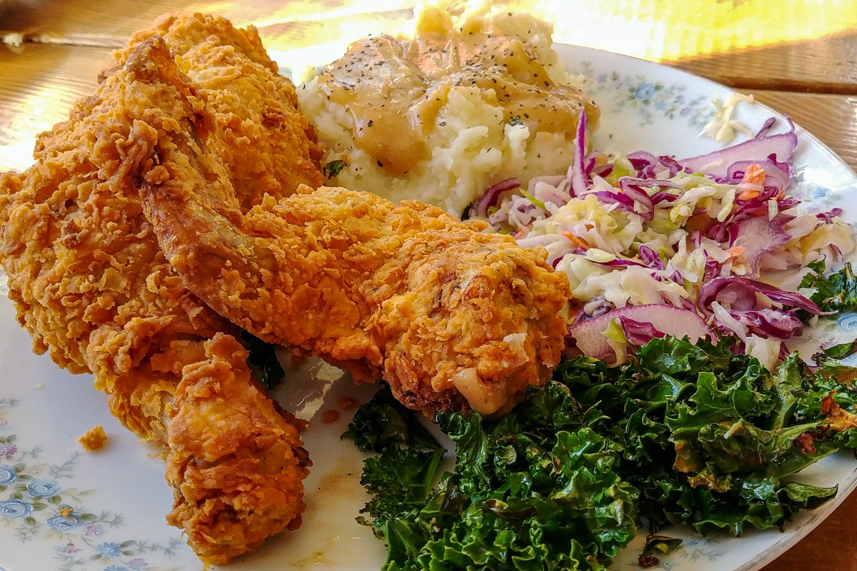 Fried chicken, potatoes & gravy, greens, and slaw.