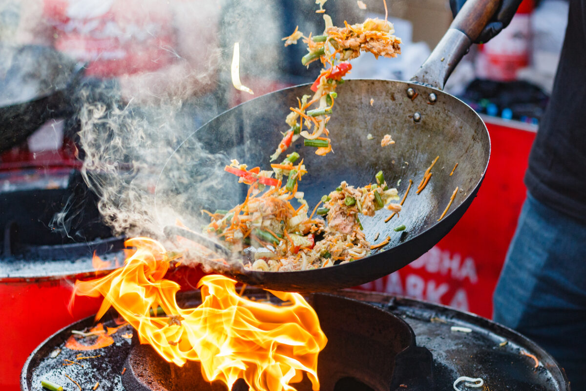 Sensory Travel Experiences: How Scent Deepens Destination Memories 3 Cooking in a wok over an open flame. One of many sensory travel experiences.