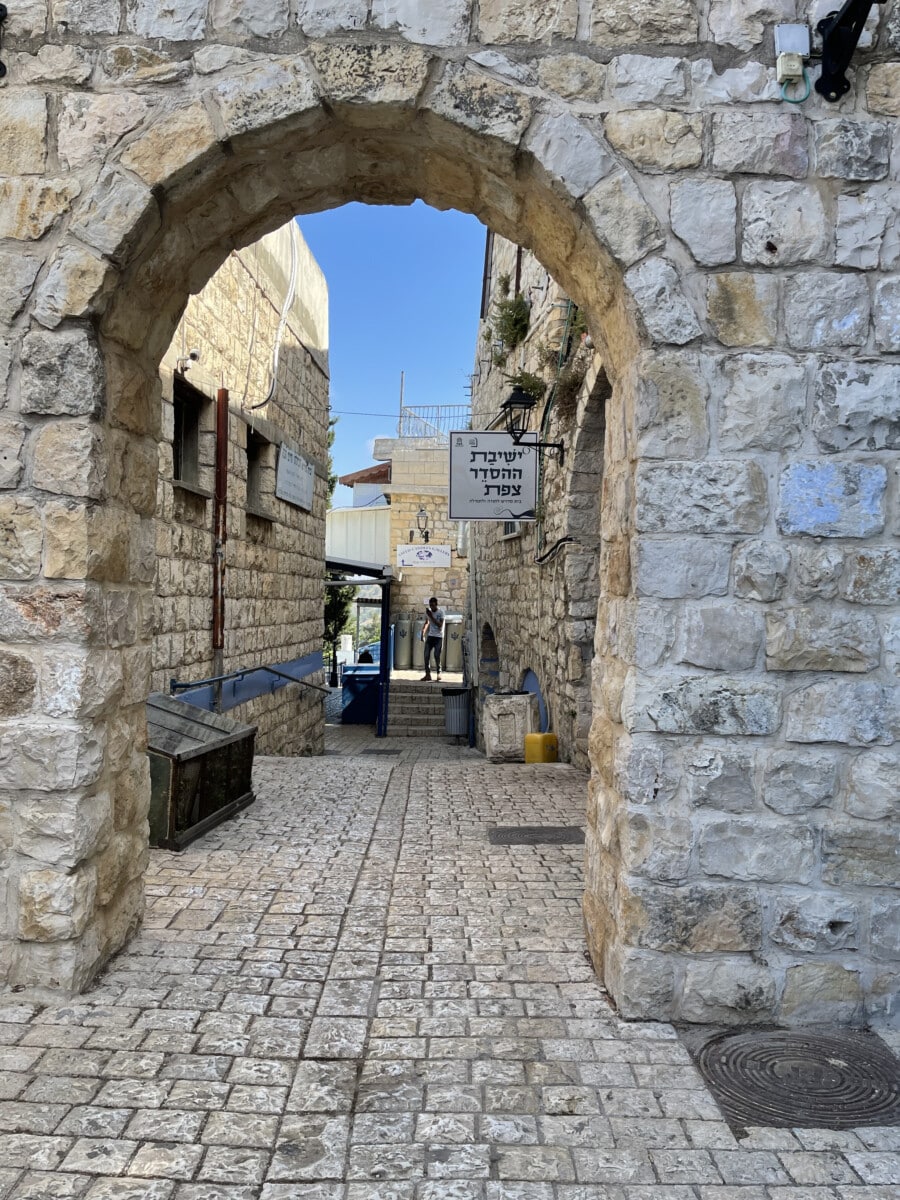 Cobbled street with an archway in Safed, Israel.