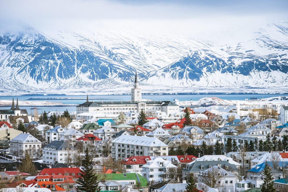 A view of Reykjavik from above with mountains in the background. One option for the best Iceland vacation experience.