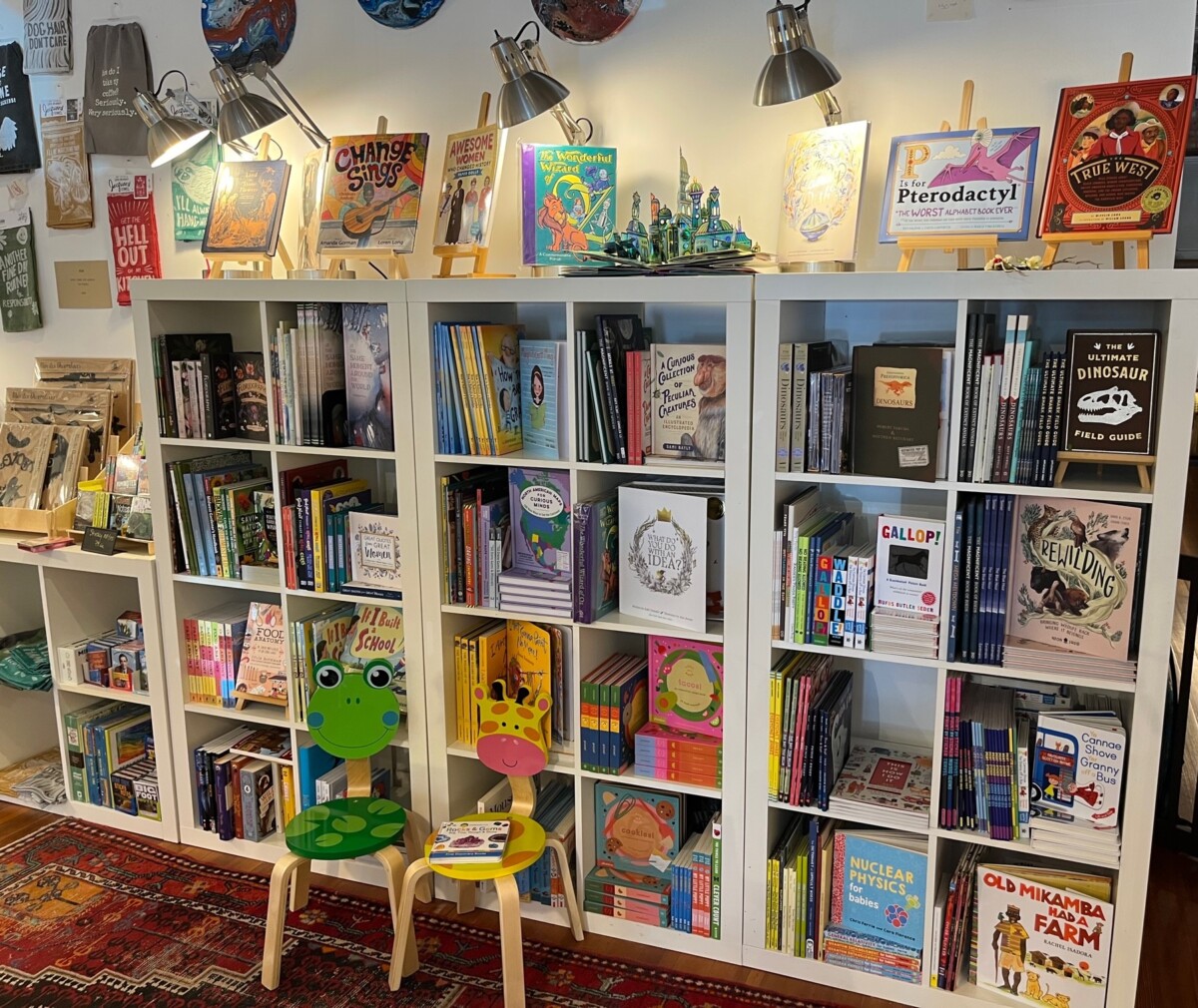 Children's books occupy one large bookshelf at Small World Gallery.