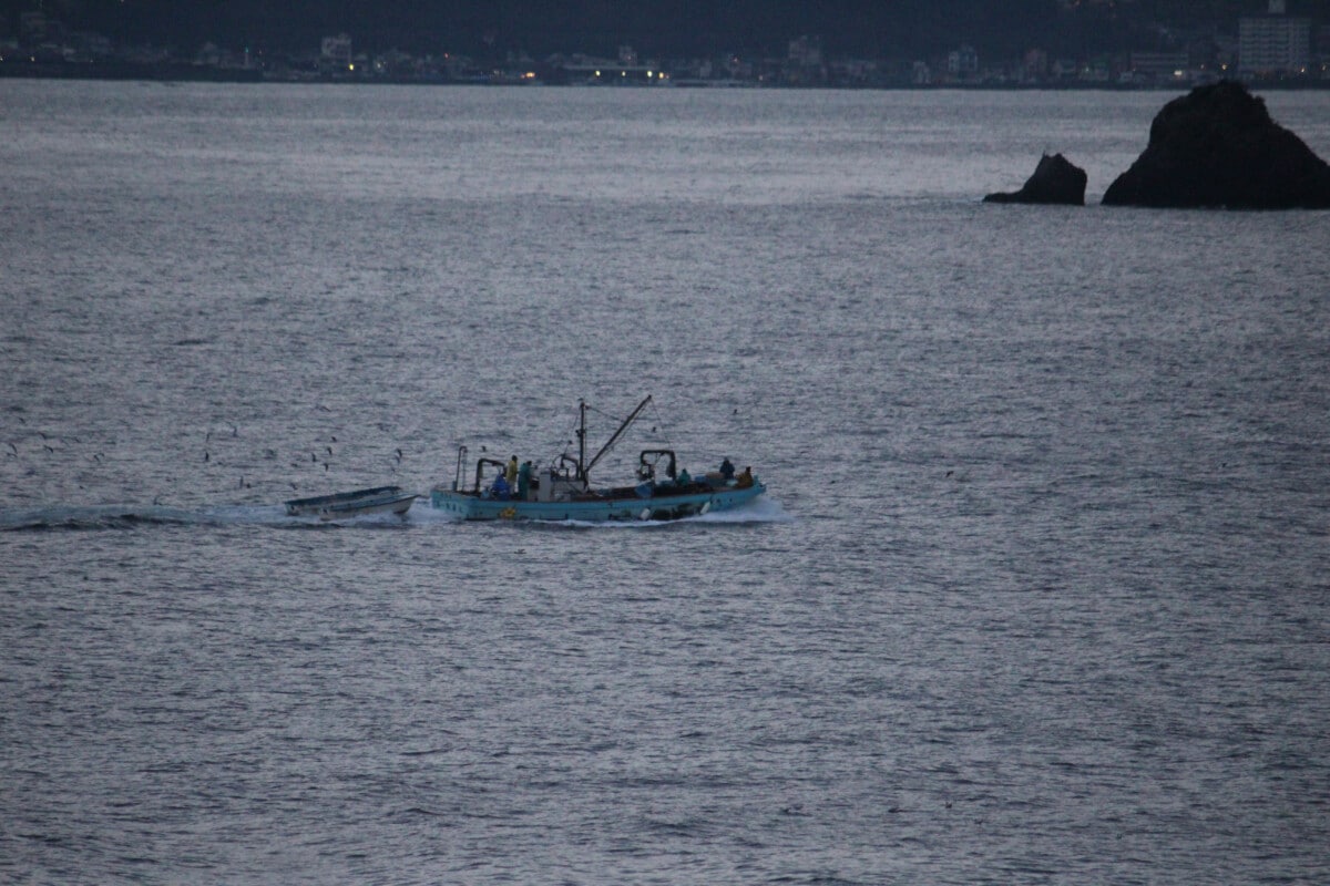 A fishing boat heads out to sea from Atami. Several small restaurants in Atami specialize in local seafood.