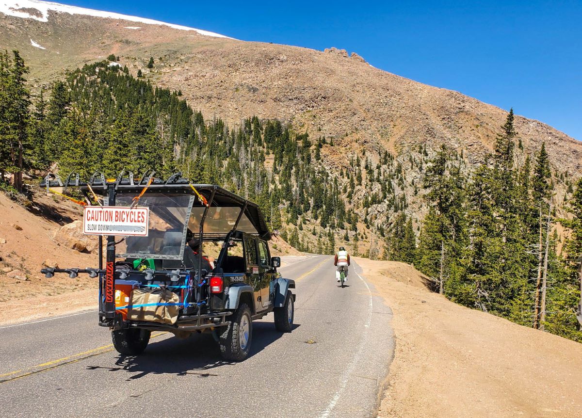 Bicycling Pikes Peak: Heart-pounding, Fast, Majestic 6 Adventures Out West vehicle stays with cyclists as they are bicycling Pikes Peak.