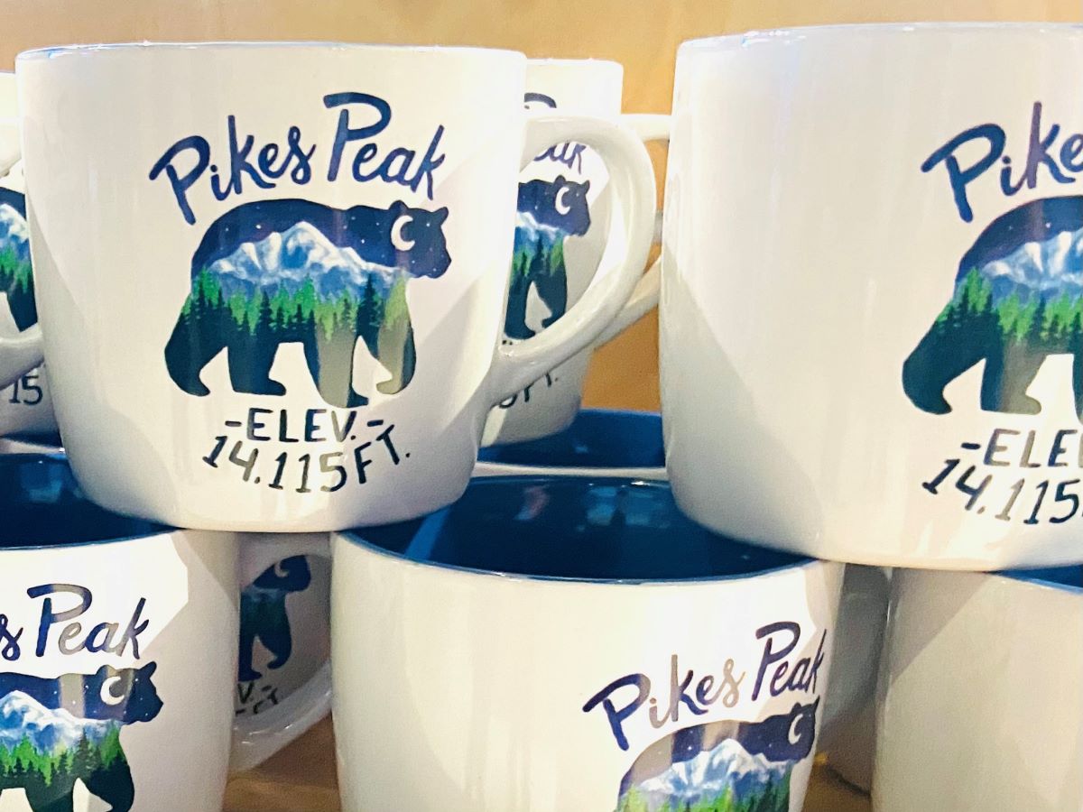 Bicycling Pikes Peak: Heart-pounding, Fast, Majestic 3 Coffee cups with Pikes Peak elevation listed for sale at the Visitors Center before bicycling Pikes Peak.
