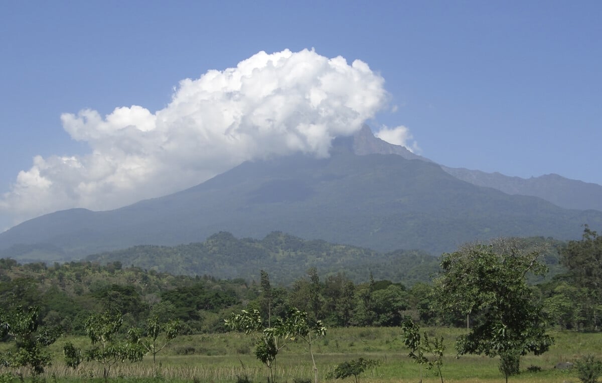 Mount Meru in Tanzania (Africa) covered in big white clouds