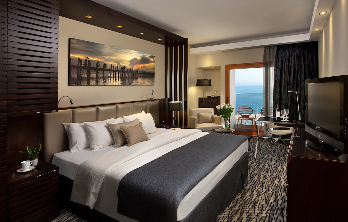 Executive guest room with balcony and a full sea view at the beach hotel in Tel Aviv.