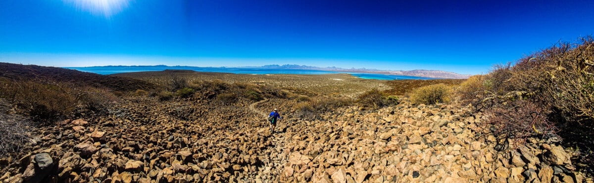 The author straggles behind the group across a lava field on Coronados Volcano during the hike to return to the beach. Photo by Ivette Granados