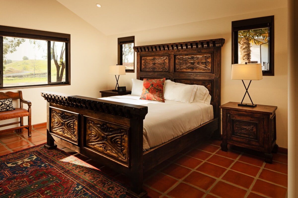 The hand-carved beds feature luxurious Italian linens at La Lomita.