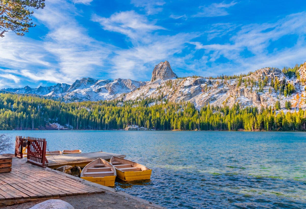 Boats sit at dock at Lake George under the watchful eye of the Crystal Crag peak. This peak is in Mammoth Lakes in Central California, in Sierra Nevada Mountains,