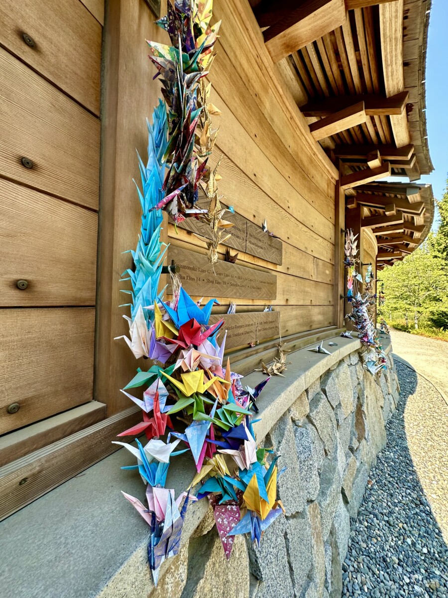 Paper cranes, symbolizing honor, good fortune, loyalty, and longevity, hang on the memorial. Photo by Susan Lanier-Graham