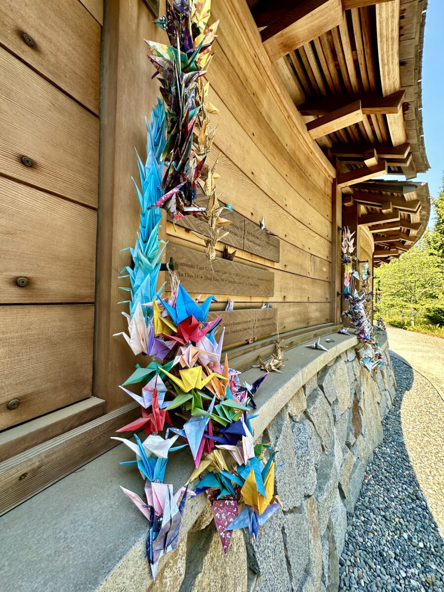 Bainbridge Island Japanese Exclusion Memorial: A Lesson for All Time 8 Paper cranes, symbolizing honor, good fortune, loyalty, and longevity, hang on the memorial. Photo by Susan Lanier-Graham