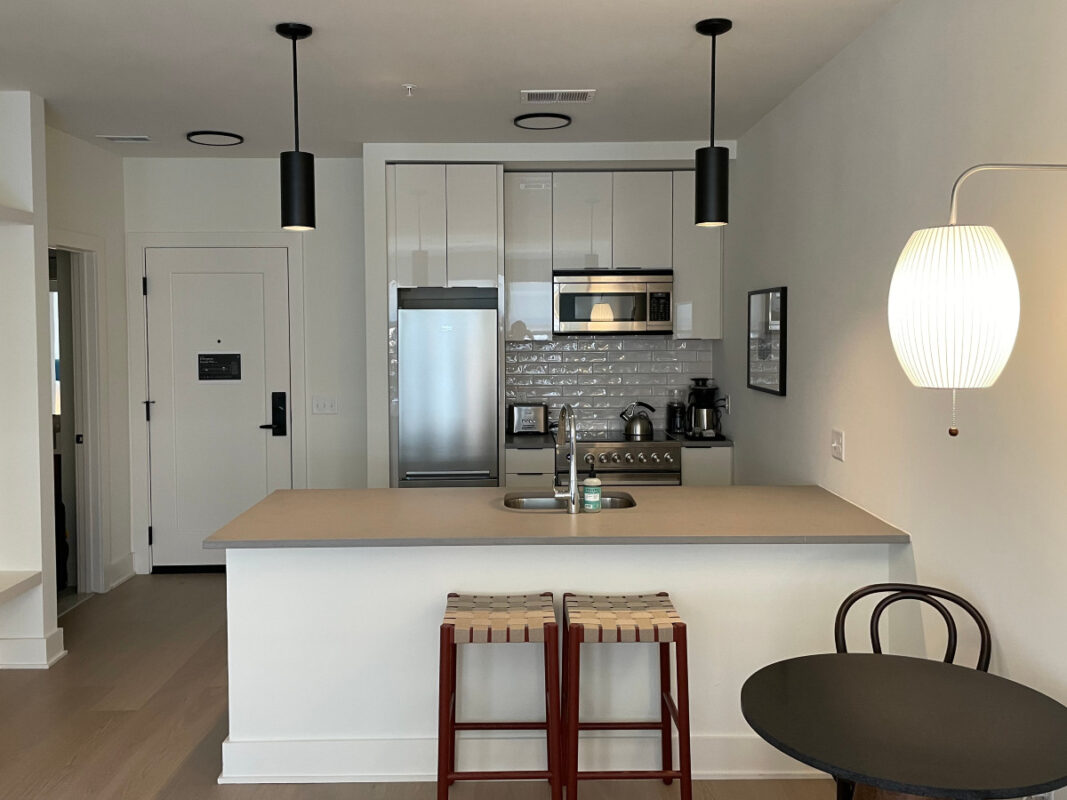 Roost Baltimore Offers Comforts of Home in a Trendy Setting 6 Small kitchen with white cabinets and stainless steel applicances