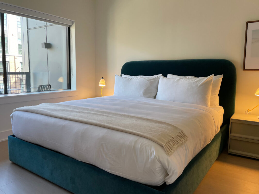 Roost Baltimore Offers Comforts of Home in a Trendy Setting 5 Bedroom with a king-sized bed with a blue headboard