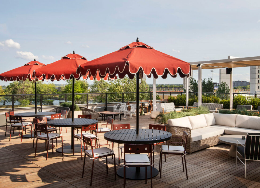 Roost Baltimore Offers Comforts of Home in a Trendy Setting 8 Rooftop terrace with bistro tables and wicker furniture.