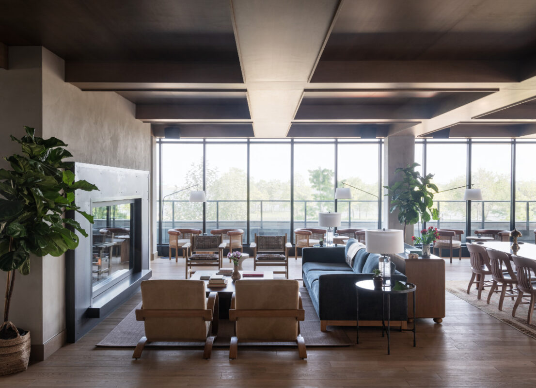 Roost Baltimore Offers Comforts of Home in a Trendy Setting 7 Large room with chairs, plants, tables, sofa, and fireplace