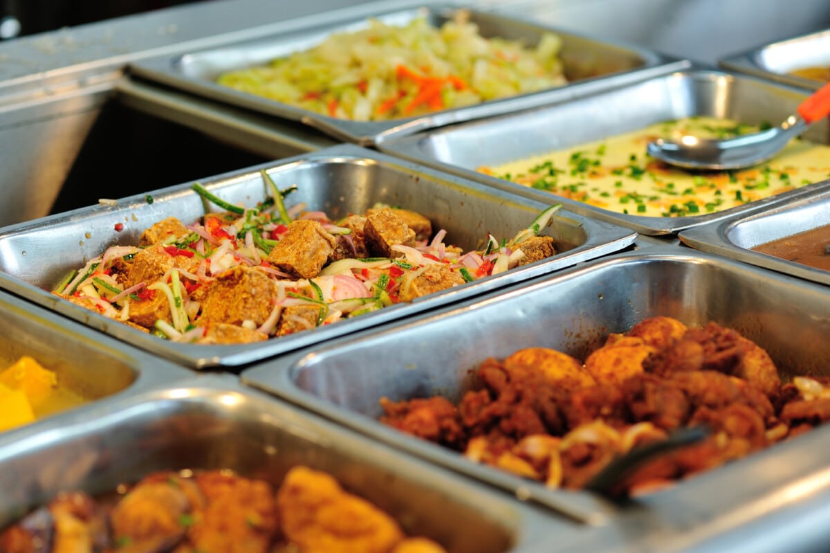 Steel tray filled with food inside the self service Chinese restaurant