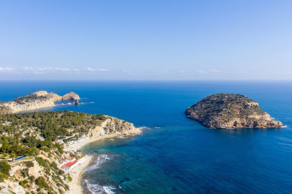 7 of the Best Secret Ibiza Beaches 2 Aerial view of Portitxol Island and Barraca beach in Javea, Spain.