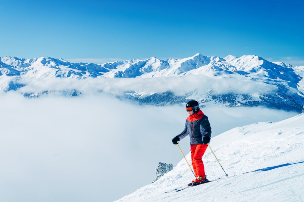 Mayrhofen, Austria - February 4, 2019: Man Skier at mountains in Zillertal Arena ski resort Zillertal in Tyrol. Mayrhofen in Austria in winter in Alps. Person at Alpine mounts with snow. Blue sky