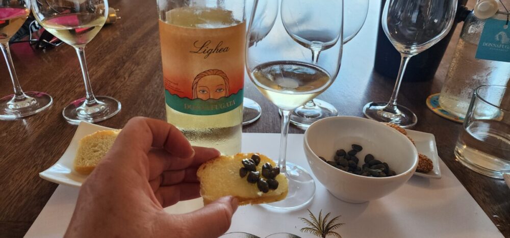 Tasting Donnafugata Wines: An Excursion Off the Coast of Sicily 14 Enjoying Donnafugata Zibbibo with capers. Photo by Alison Levine