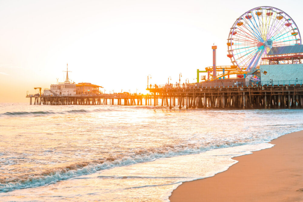 Exploring Los Angeles: What to Expect When Visiting the City of Angels 1 Santa Monica Pier on the background of an orange sunset, calm ocean waves, Los Angeles, California