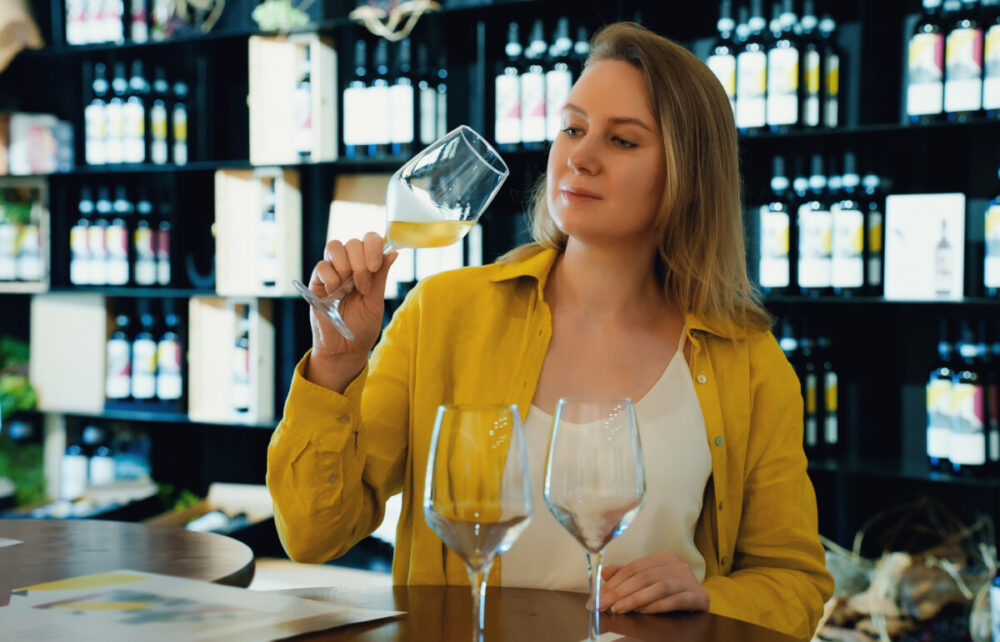 Past the First Five Results: How to Eat Well in an Unfamiliar Town 5 Woman is tasting white wine at a winery.