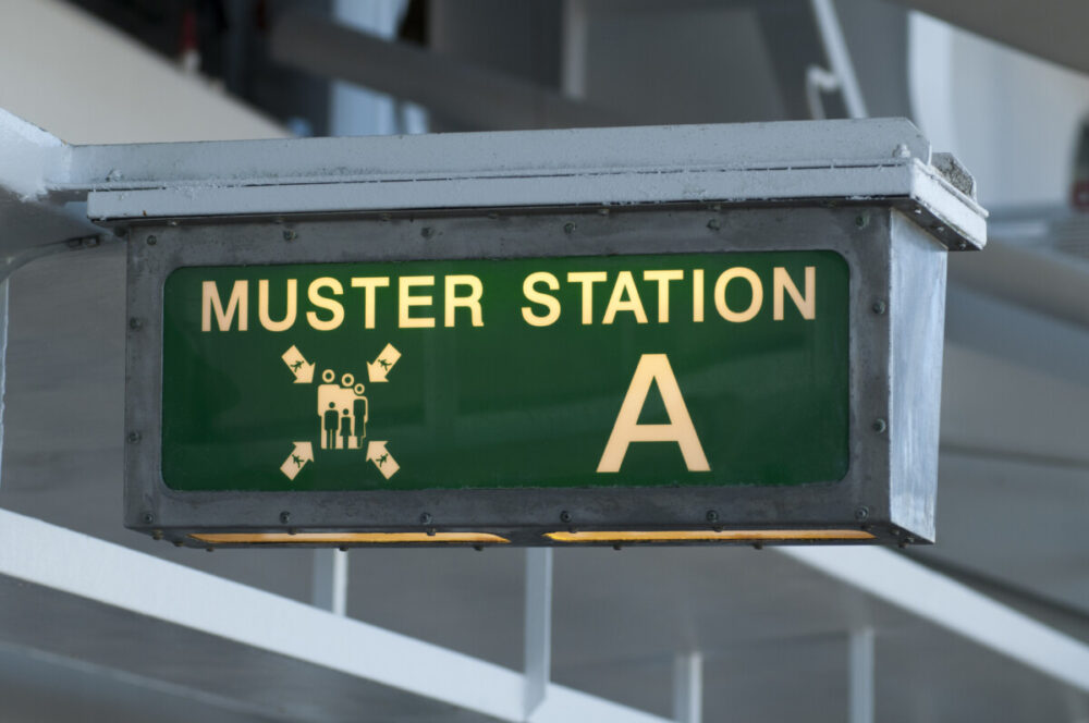 Muster station sign directing passengers to the life boats on a cruise ship. Photo by CARLOSVOSS via iStock by Getty Images