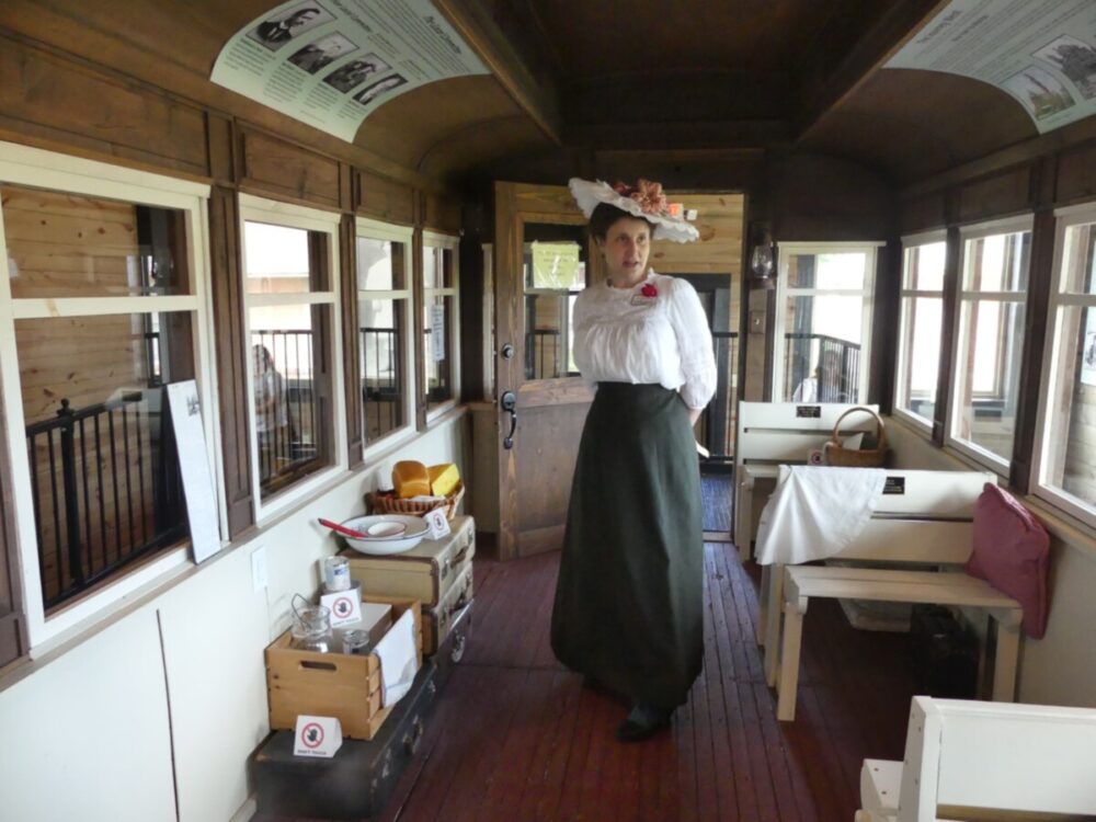 Discover the Magic of a Fun and Quirky Kansas Road Trip 12 Docent in costume as Anna Laura Hill in Legends train car