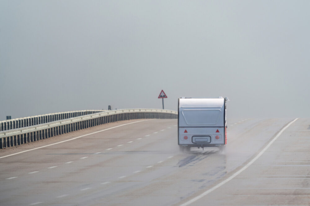 Top 4 Tips for Safe RV Travel on Highways 4 RV driving on the motorway in the rain. Motorway in the rain