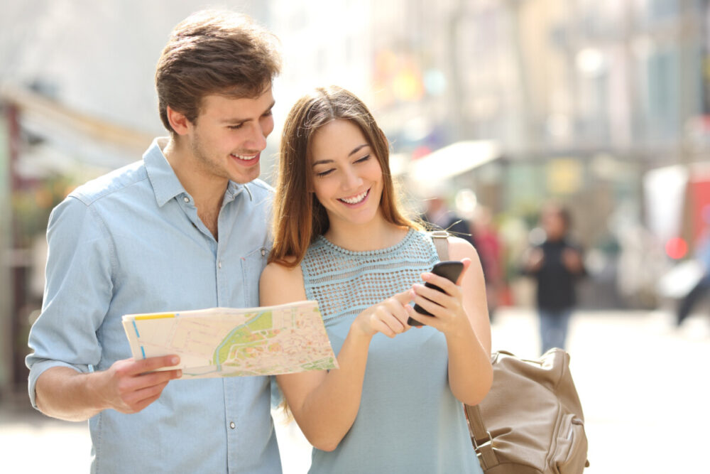Cybersecurity Tips for Travelers Visiting Southeast Asia and Dubai 1 Couple of tourists consulting a city guide and smartphone gps in the street searching locations. Best eSIM plans for Taiwan