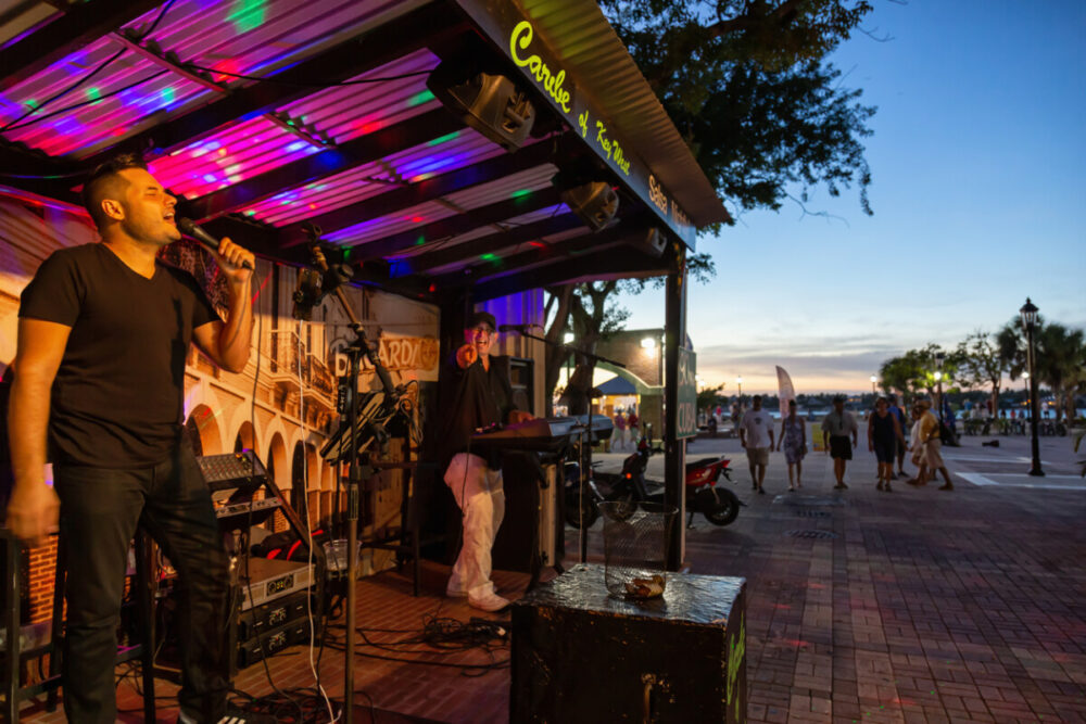 Key West, Florida, United States - November 1, 2018: Musicians are doing a street performance during sunset at Mallory Square.