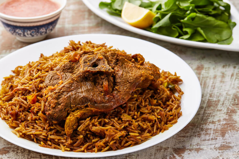 Meat Machboos or beef majboos rice with lemon slice served in dish isolated on table top view of arabic food
