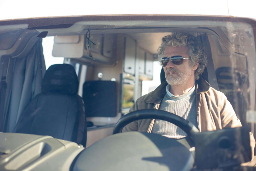 man with sunglasses driving an RV