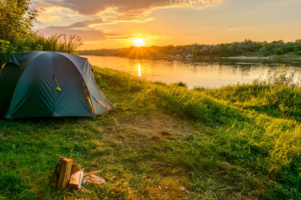 tent on the banks of a river
