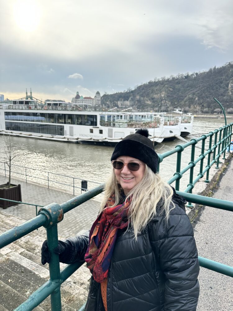 Susan in winter clothing outside the Viking Vilhajalm in Budapest