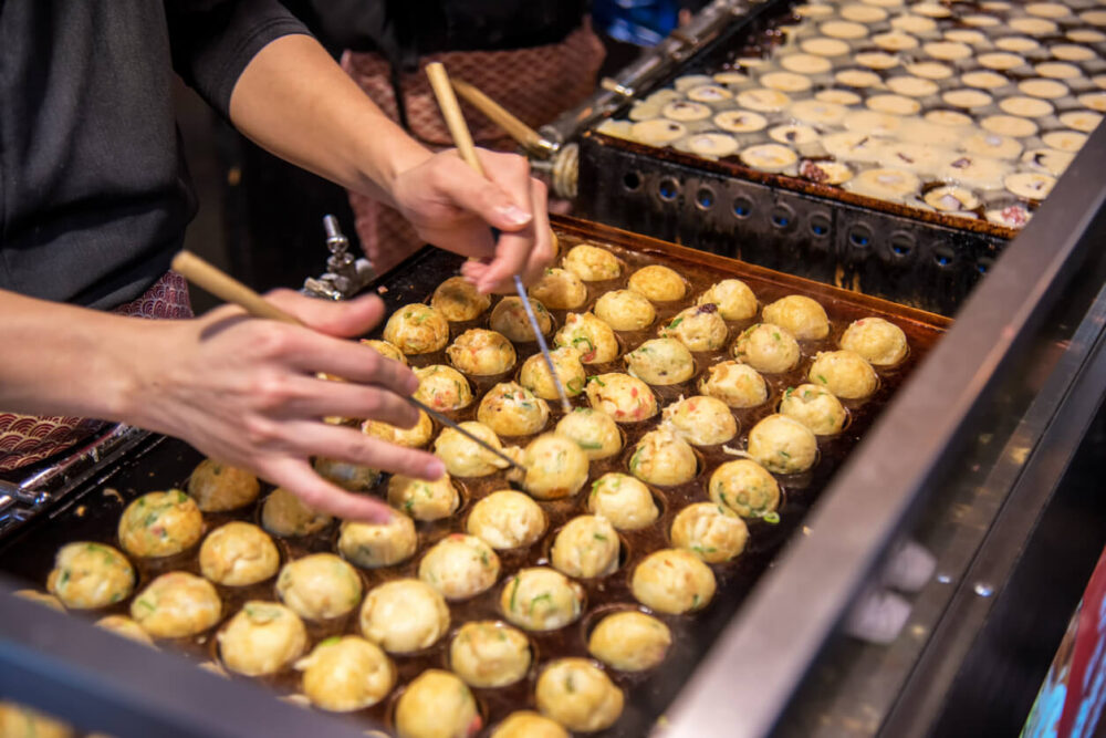 cooking takoyaki in Osaka