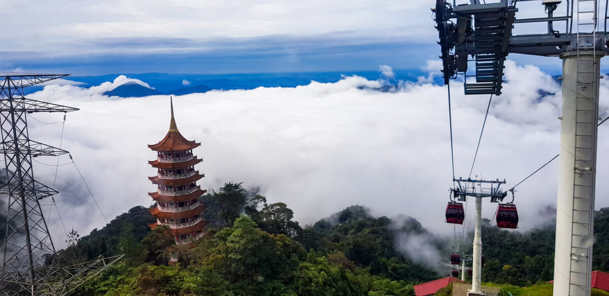 cable car at genting highlands, malaysia in a foggy weather with chin swe chinese temple visible from inside cable car
