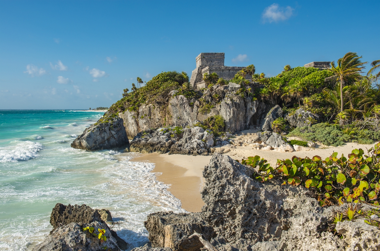 Mayan ruins on a bluff above a tropical beach in Tulum Mexico. Tulum for couples.