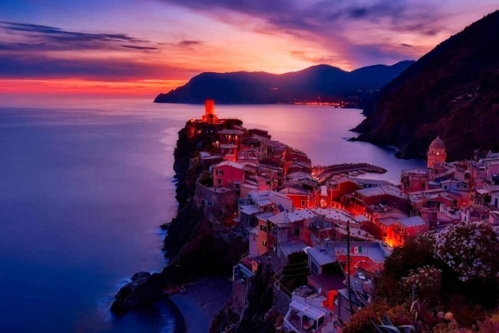 Houses on the coast at sunset in Vernazza, Italy. Best Italian tour companies.