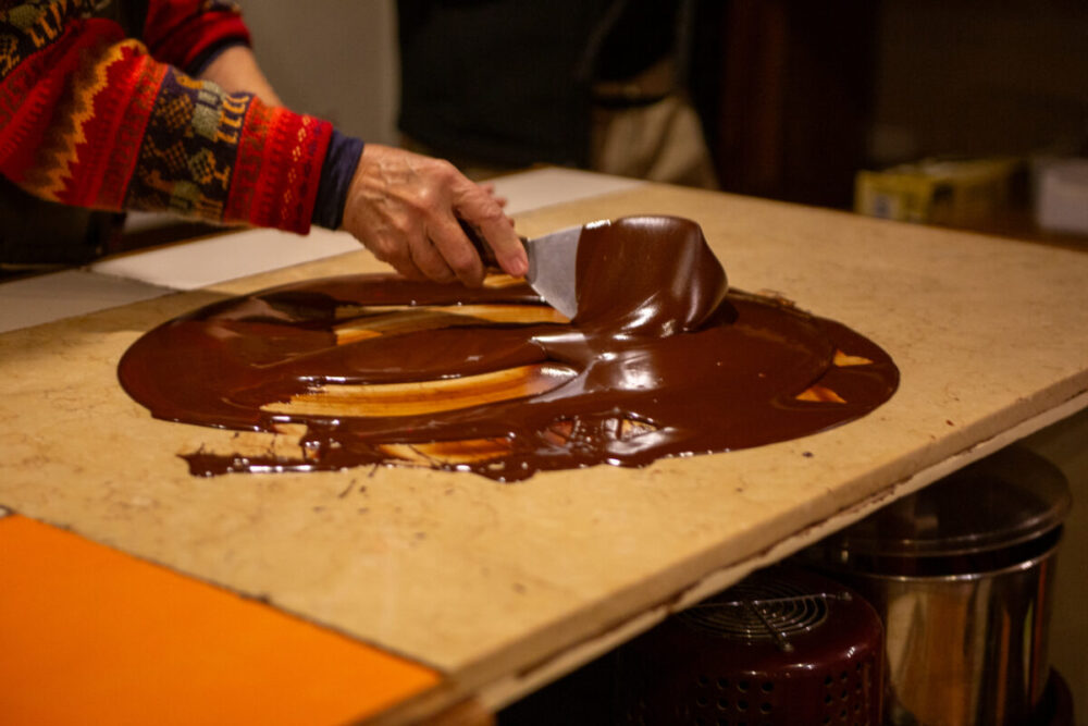 Souvenirs Worth Buying During a Multi-Country Journey 4 Chocolatier spreading chocolate as a demonstration