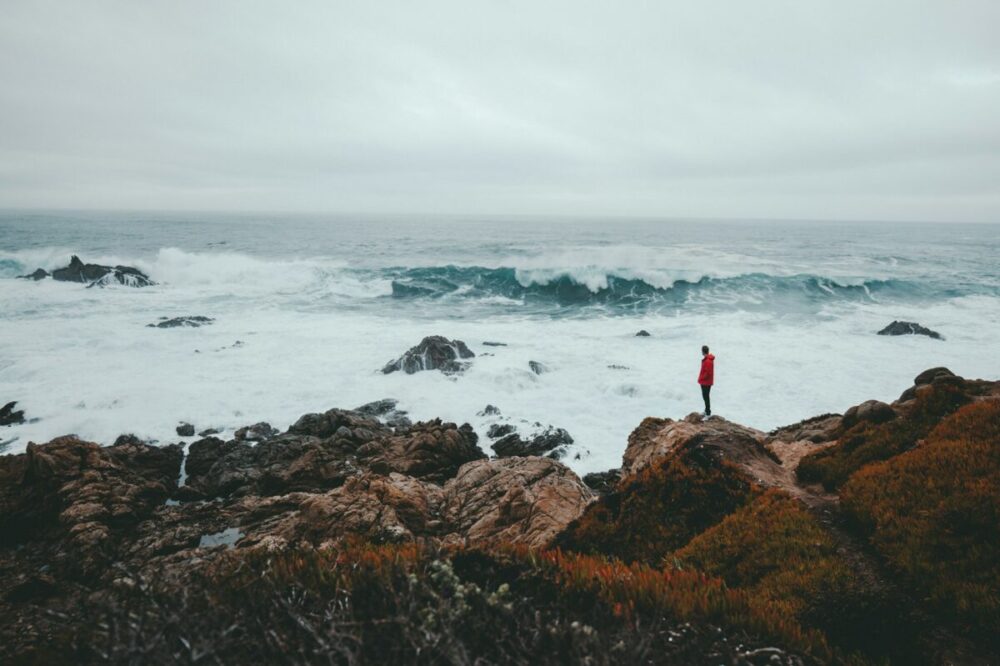Preserving Travel Photos Matters More Than Backing Up Your Phone 2 A person looking at a rough sea from the cliffside.