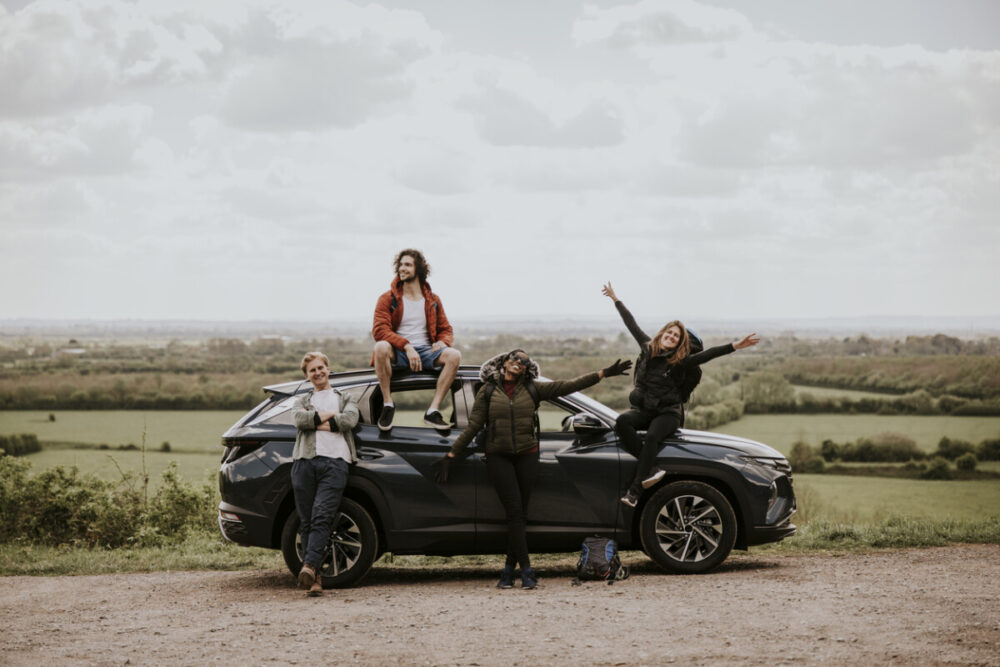 First Time Renting a Car? Here’s What to Know Before You Go 3 Friends enjoying road trip on hill photo