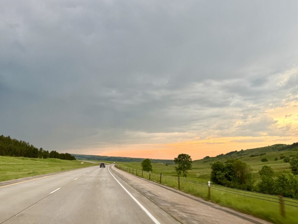 Black Hills, South Dakota Summer Travel Guide: Best Things to Do and Where to Go 3 road through the Black Hills of South Dakota with sunset beyond it