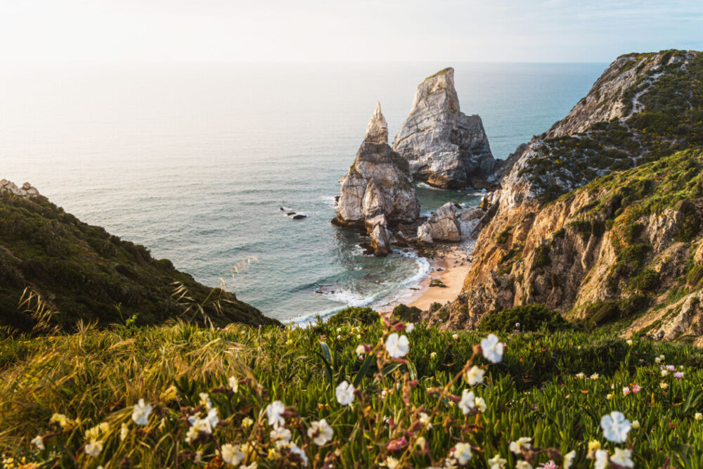 The Secret Corners Of Portugal That Most Travel Guides Don't Tell You About 4 Praia da Ursa's stunning coastal view in Sintra, Portugal.