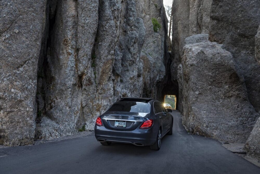Black Hills, South Dakota Summer Travel Guide: Best Things to Do and Where to Go 13 a car entering narrow tunnels through granite rock