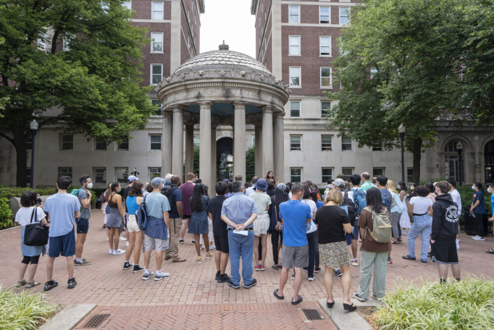 Turning College Visits Into Family Adventures 1 A large group of visitors are seen on a campus tour at the John Howard Van Amringe Memorial in the Columbia University in Upper Manhattan, New York City.