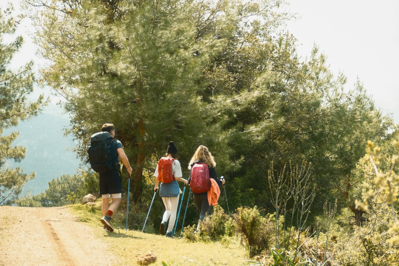 7 Travel Apps Outdoor Adventurers Are Using in 2026 5 A group of young hikers exploring the lush forests of Fethiye, Turkey, during spring.