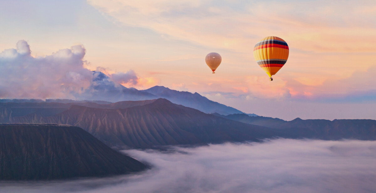beautiful inspirational sunrise landscape with hot air balloons in sky, nature travel destination, scenic view banner background